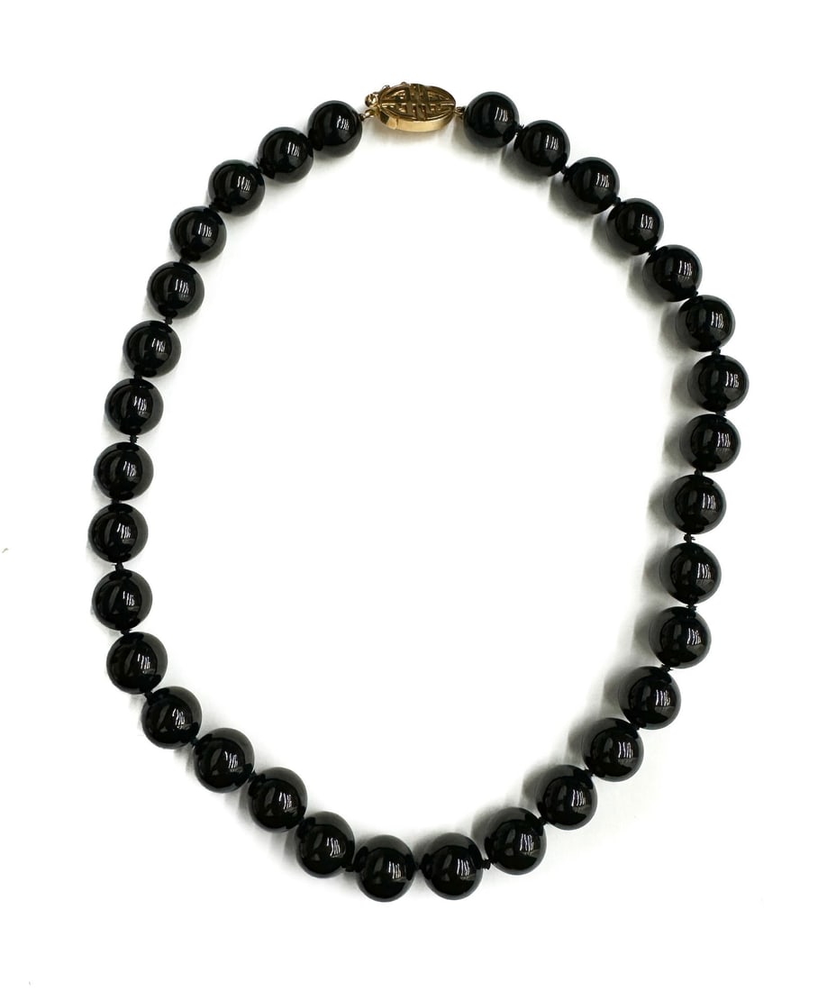 Gump's 14k Yellow Gold and Onyx Single Strand Necklace: Gump's 14k Yellow Gold and Onyx Single Strand Necklace. The onyx beads measuring approximately 12.83mm. Marked 14k Gump's to clasp. With Gump's pouch and box. Weight Approx., 110.54 grams Measures App