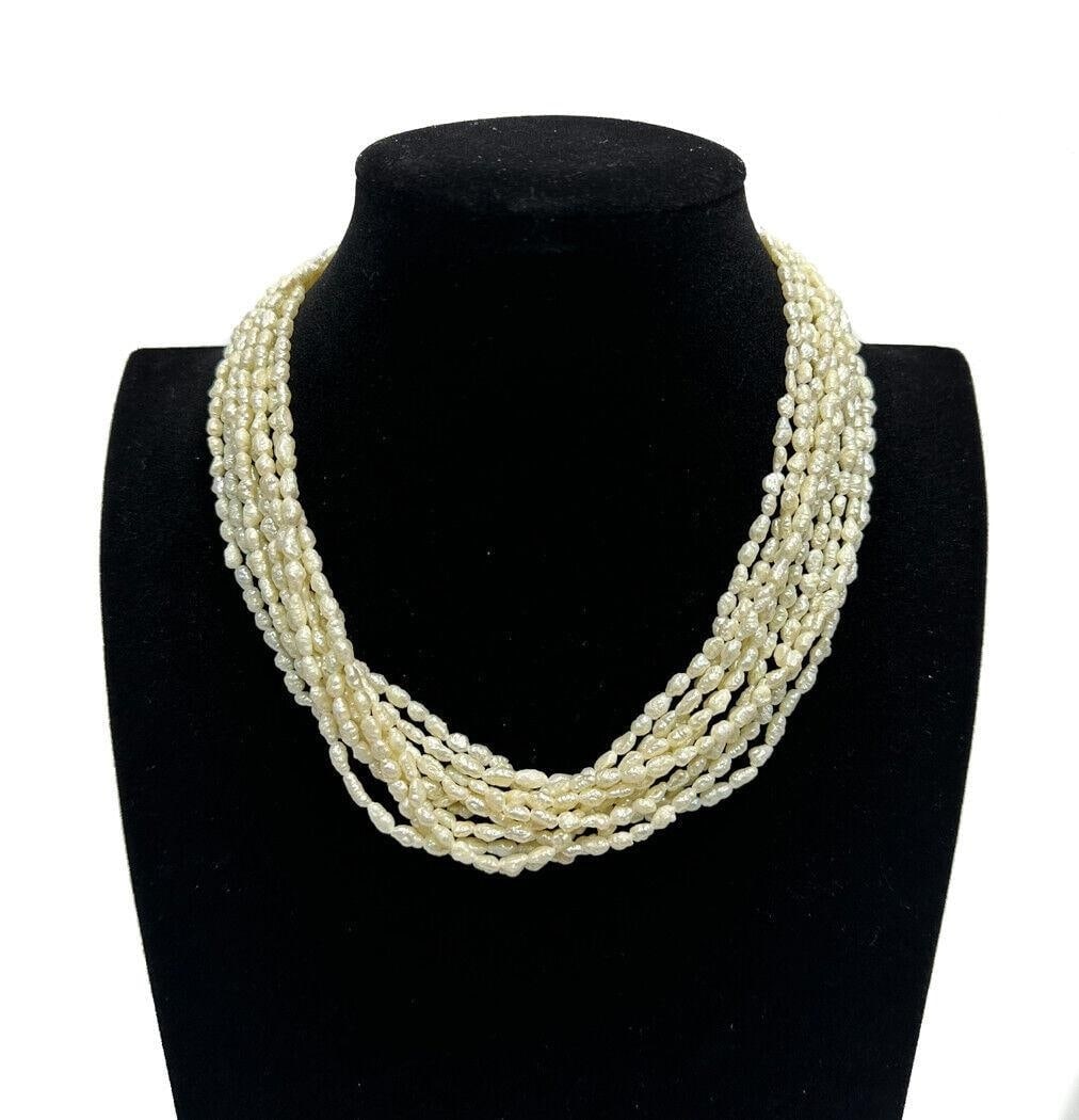14k Yellow Gold 10 strand Fresh water pearl necklace: 14k Yellow Gold 10 strand Fresh water pearl necklace. Marked "14k" to the clasp with two cultured pearls to either side. Weight Approx., 531.11 grams Measures Approx., 17 inches length Domestic Shippi