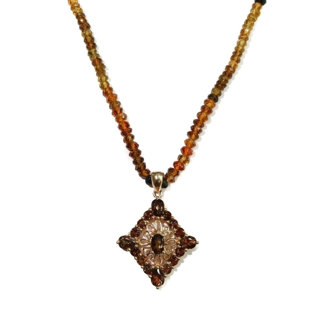 14k Yellow Gold Smokey Quartz Necklace: 14k Yellow Gold Smokey Quartz Necklace. Multi-colored quarts to chain of necklace and diamond shaped pendant. Marked "14k" to hook. Weight Approx., 16.78 grams Measures Approx., 18.5 inches length Dom