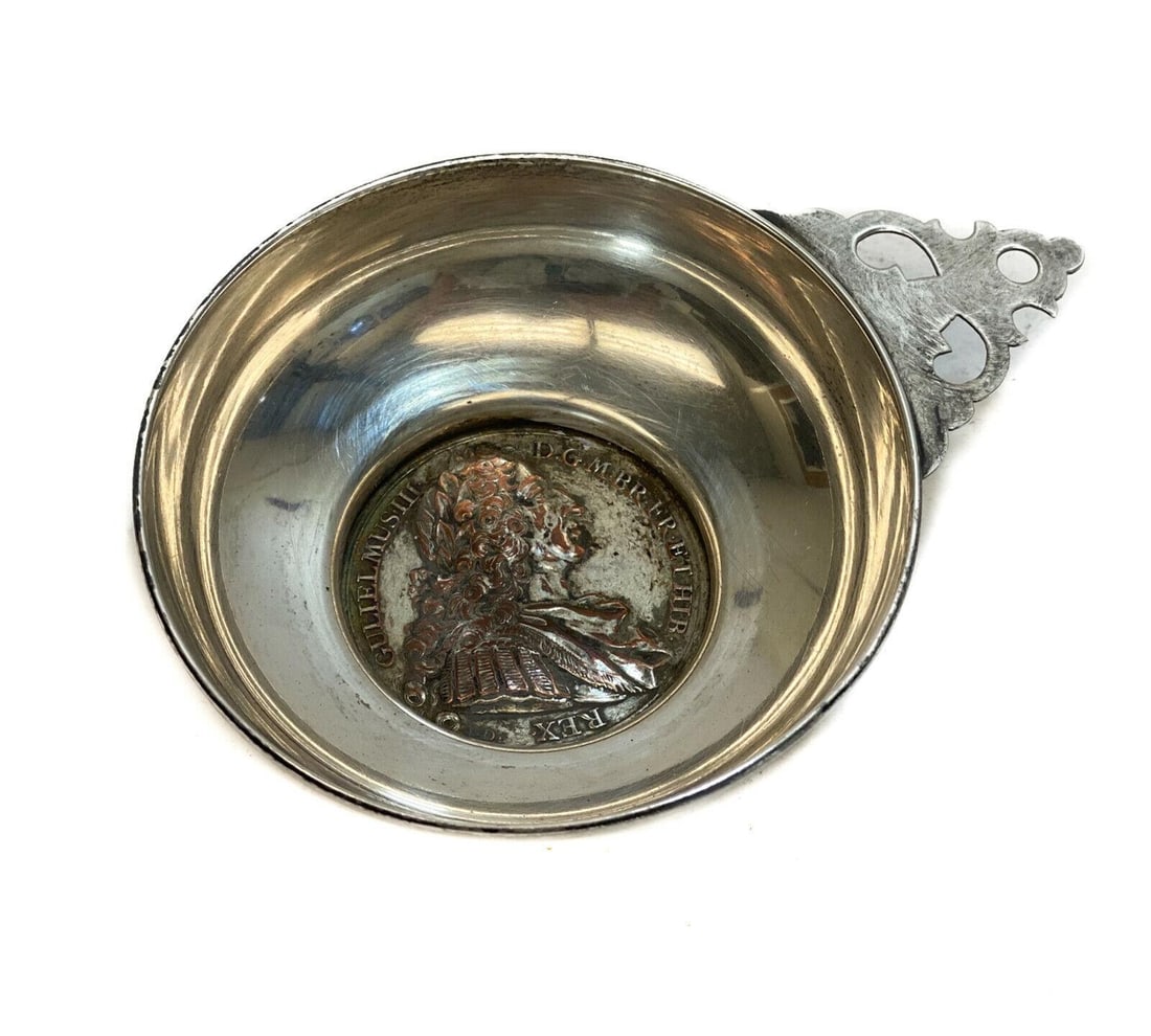 Sterling Silver and Greek Coin Mounted Inset Tastevin: Sterling Silver and Greek coin mounted inset tastevin. Sterling silver mark to the rim of the base. Weight: Approx. 1.73 ozt Measurements: Approx. 4.25 inches x 3 inches x 1 inch Condition: Very good