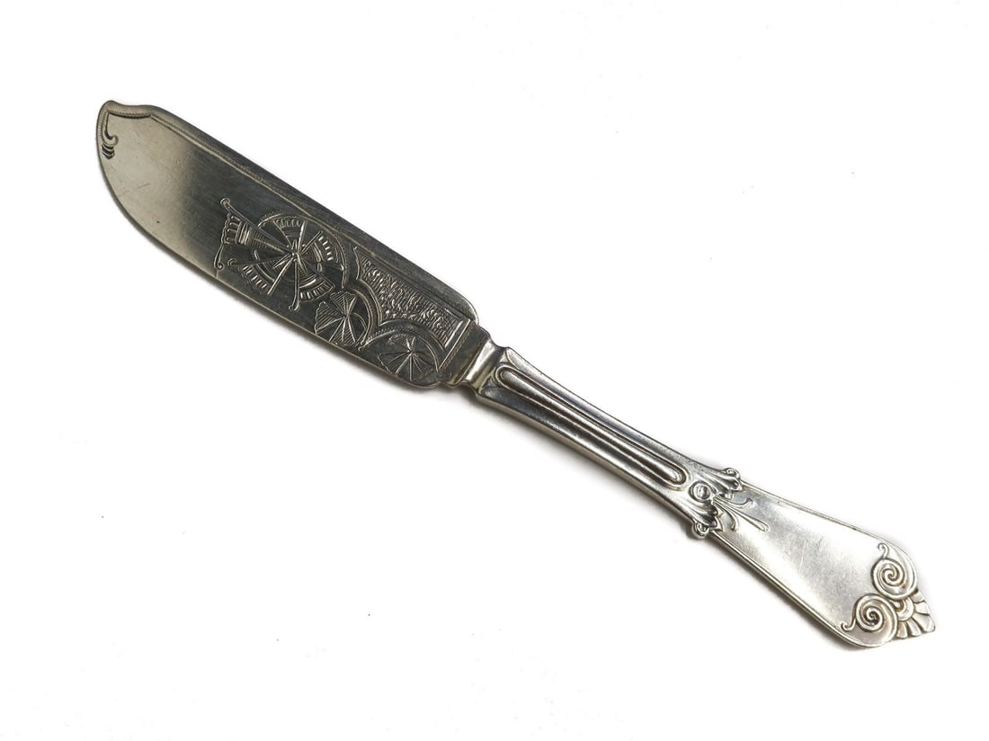 Tiffany & Co. Sterling Silver Fish Knife in Tiffany: Tiffany & Co. Sterling Silver Fish Knife in Tiffany. Etched scrolls to hand with leaf designs to blade. Marked Tiffany & Co. to back of blade. Weight: Approx. 1.742 ozt Measurements: Approx. 7.25