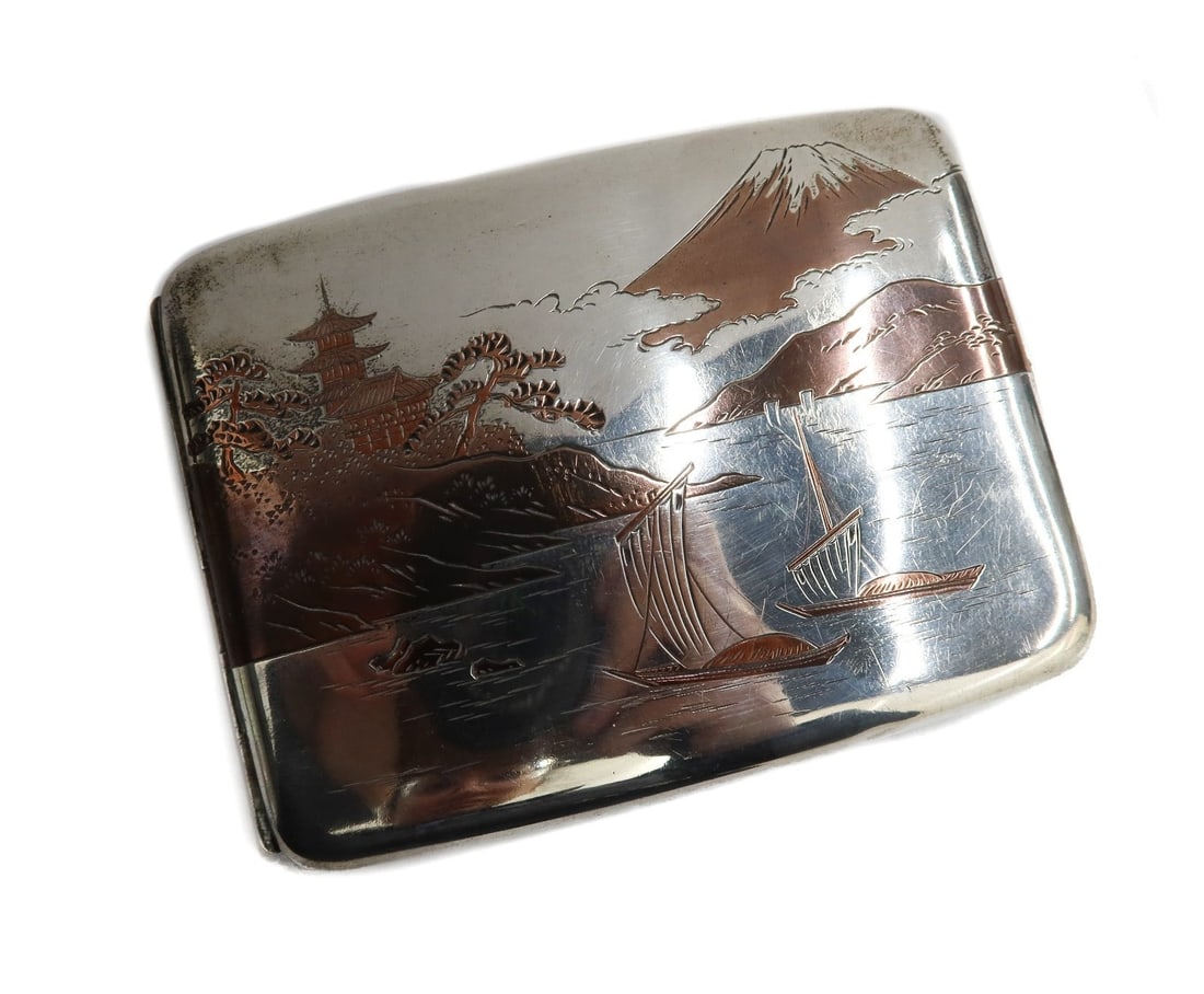 Japanese Mixed Metal Sterling Silver Cigarette Case Mount Fuji circa 1920: Japanese mixed metal sterling silver cigarette case Mount Fuji, circa 1920. Depicts a pagoda shrine, boats on a lake, and Mount Fuji in the background. Marked "Sterling" to interior. Weight: Approx.