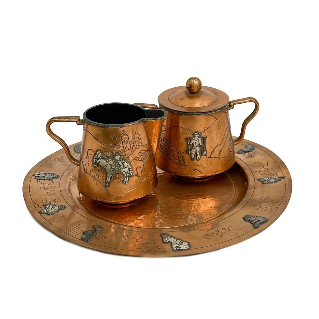 Victoria Taxco Mexico Applied Silver Copper Cream & Sugar with Tray #267: Victoria Taxco Mexico Applied Silver Copper Creamer and Sugar with Tray, mid century. Copper body with applied silver desert scenes with figures to the sides. Underside marked Victoria Taxco Mexico 26