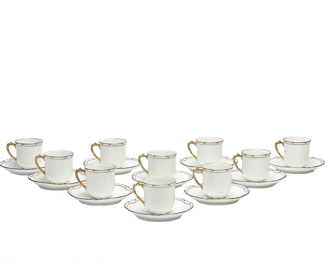 10 Limoges France Gilt Porcelain Coffee Cups & Saucers circa 1915: 10 Limoges France porcelain coffee cups & saucers, circa 1915. A white ground with raised gilt beading to the edge, gilt to the scalloped rim, cups with shaped feet. Underside with marks for Mandavy d