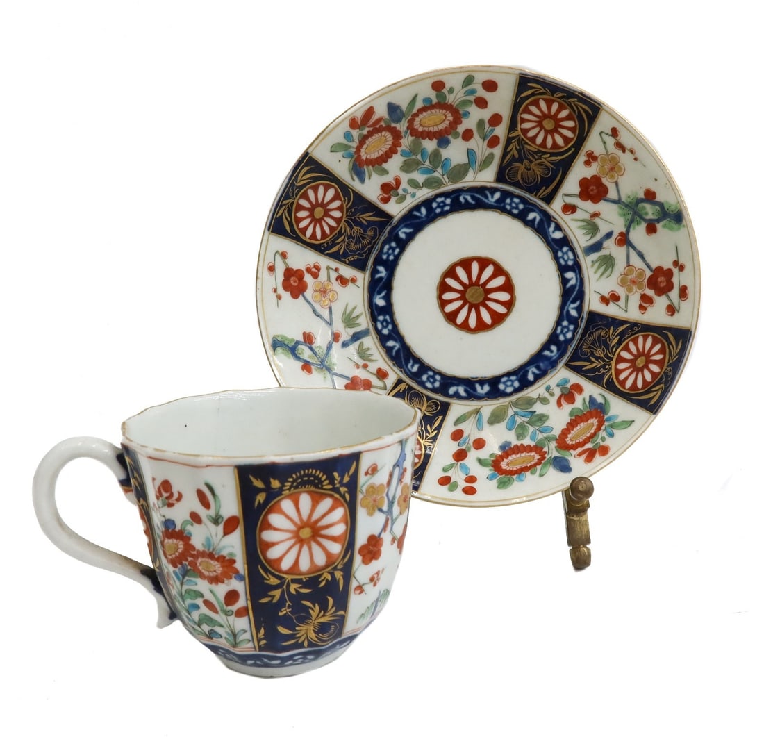 Royal Worcester England Porcelain Cup and Saucer Queen's Pattern Imari c1770: Royal Worcester England porcelain cup and saucer in Queen's Pattern imari kakiemon, circa 1770. White and blue panels with gilt accents and hand painted orange flowers throughout. Royal Worcester blue
