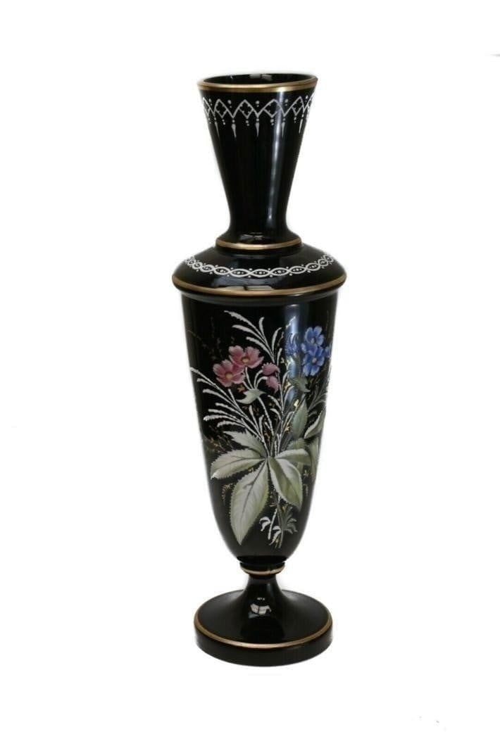 French Black Opaline Glass Hand Painted Footed Vase, circa 1930: French black opaque glass hand painted footed vase, circa 1930. Beautiful hand painted enamel pink and blue florals and leaves to the central image. Unmarked. Measures Approx., 4 inches diameter x 13.