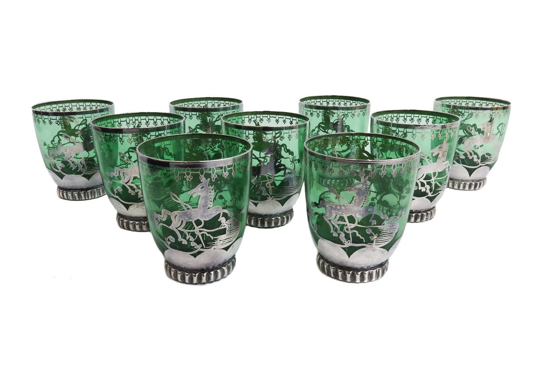 9 Murano Green Colored Glass and Silver Overlay Tumbler Goblets: 9 Murano green colored glass and silver overlay tumbler goblets. Silver overlay horses to the center with a monogram "AR" Weight: Approx. 4 lb Measurements: Approx. 3.125 inches diameter x 3.75 inches