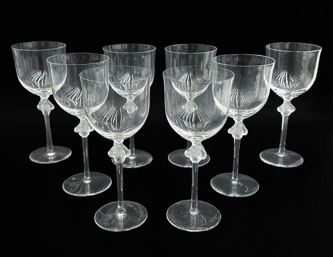 8 Lalique France Crystal Tall Water Glass Goblets in Roxane Signed: 8 Lalique France Crystal Tall Water Glass Goblets in Roxane Signed. 2 frosted nude figures embracing grapes or flowers to stems. Marked Lalique France to underside. Weight: Approx. 8 lbs Measurements: