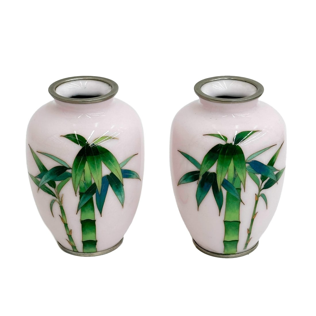 Pair Japanese Cloisonne Enamel Vases Pink with Bamboo Showa period: Pair Japanese Cloisonne Enamel Vases, Showa period. A pink ground with cloisonne green bamboo. Metal mounts Weight: Approx. 2 lb Measurements: Approx. 3.25 inches diameter x 5 inches tall Condition: G