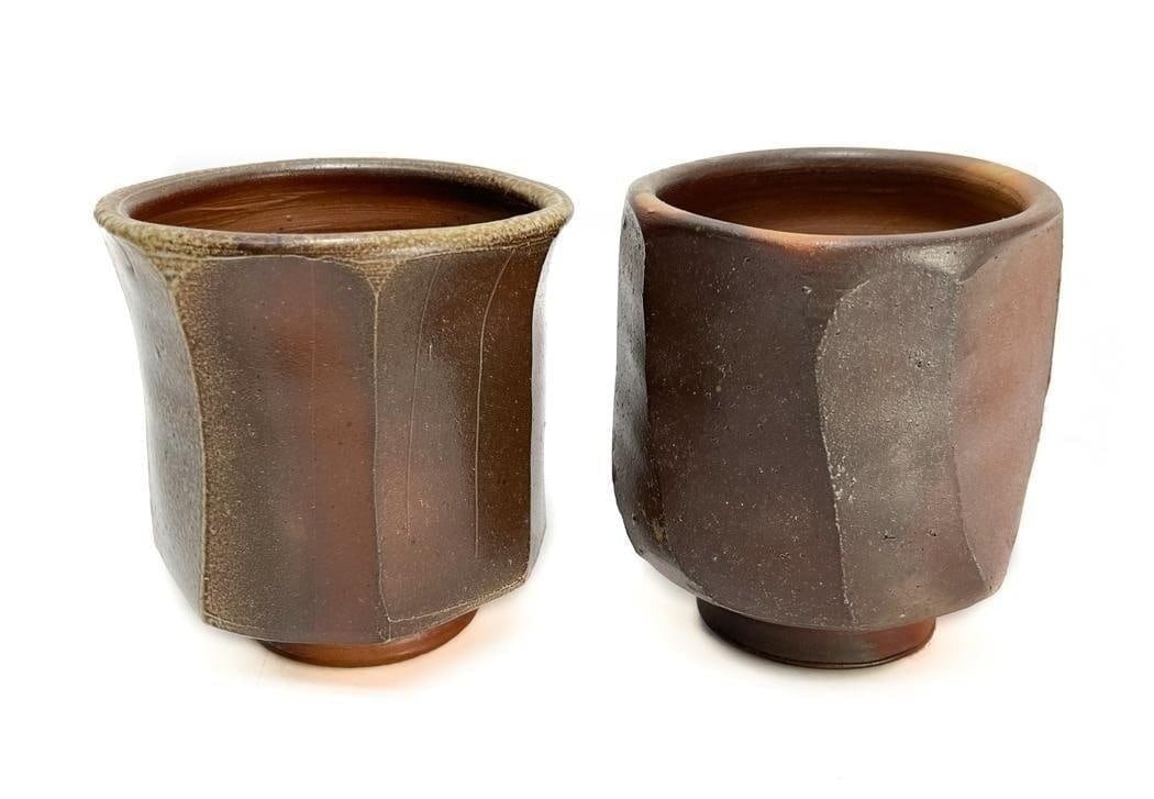 Pair Modernist Ceramic Footed Tumblers or Vases: Pair Modernist Ceramic Footed Tumblers or Vases. Signed with two carved circles to the base. Weight Approx., 1 lbs Measures Approx., 3.5 inches diameter x 4 inches tall Domestic Shipping: $50