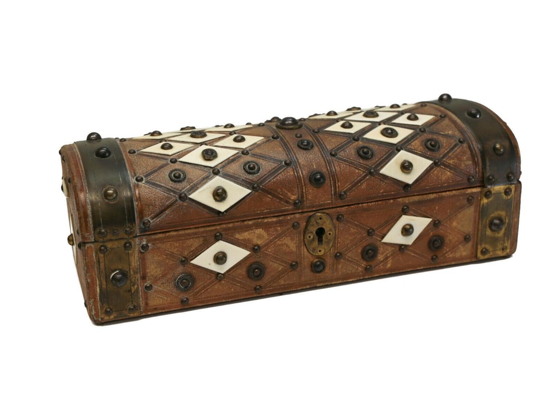 WTnS Leather Wood Box, circa 1930. Hand Tooled Leather & Faux Jewels: WTnS leather wood box, circa 1930. Hand tooled leather, faux jewels, beaded rivets . Diamond cut designs throughout. Weight: Approx. 1 lb Measurements: Approx. 10 inches x 4.5 inches x 3.5 inches tall