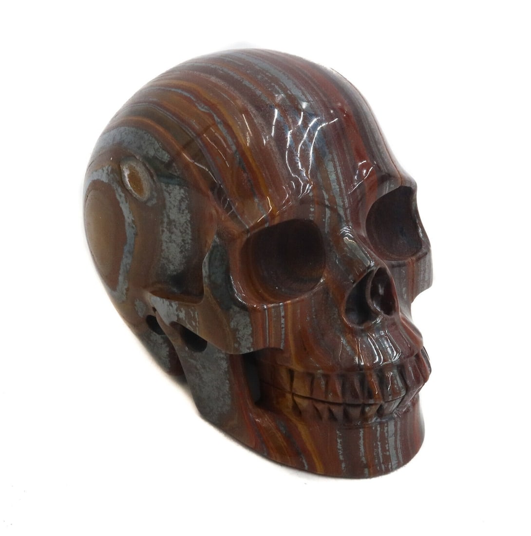 Tiger's Eye Carved Skull Figurine: Tiger's Eye Carved Skull Figurine Weight: Approx. 1516 grams Measurements: Approx. 5 inches x 3.25 inches x 4 inches tall Domestic Shipping: $40