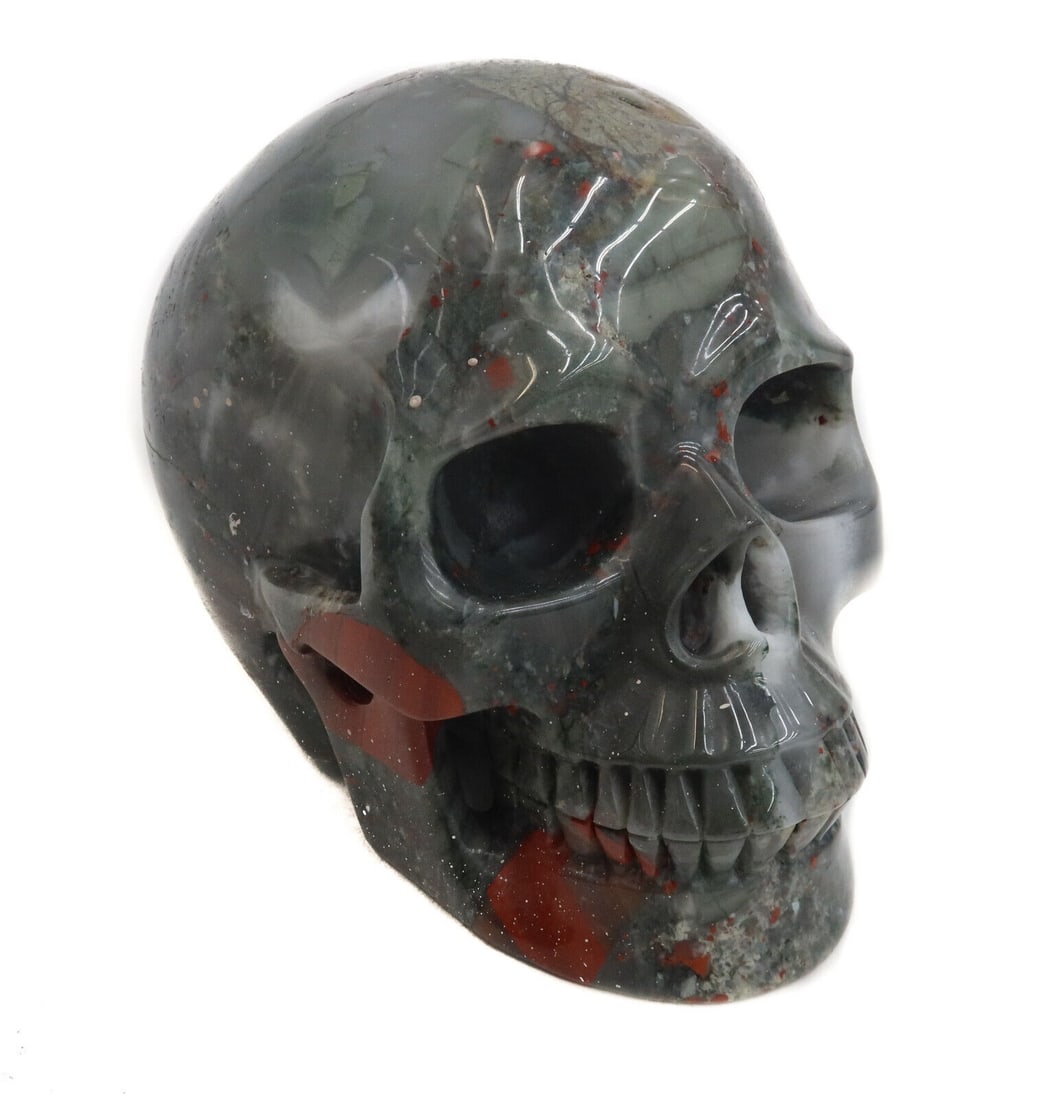 Carved Red Grey and White Agate Skull Figurine: Carved Red Grey and White Agate Skull Figurine Weight: Approx. 3466 grams Measurements: Approx. 6 inches x 4 inches x 5.5 inches tall Domestic Shipping: $40
