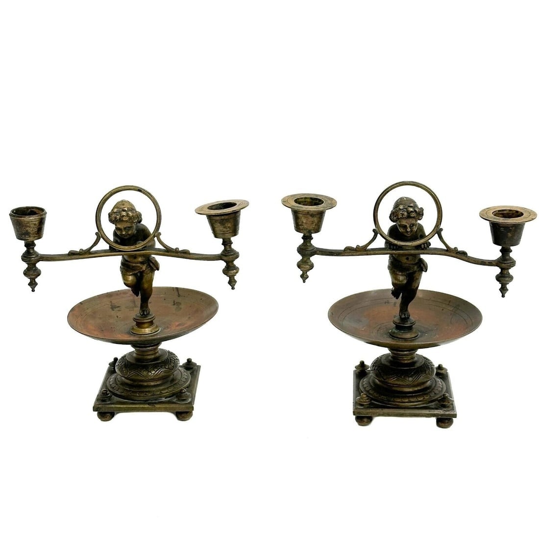 Pair Continental Bronze Two Light Candelabras Putti with Rings early 20th cen: Pair Continental Bronze Two Light Candelabras, early 20th century. Depicts a pair of putti holding rings, two candle holders to each side. Bowl form bases. Weight: Approx. 6 lbs Measurements: Approx. 