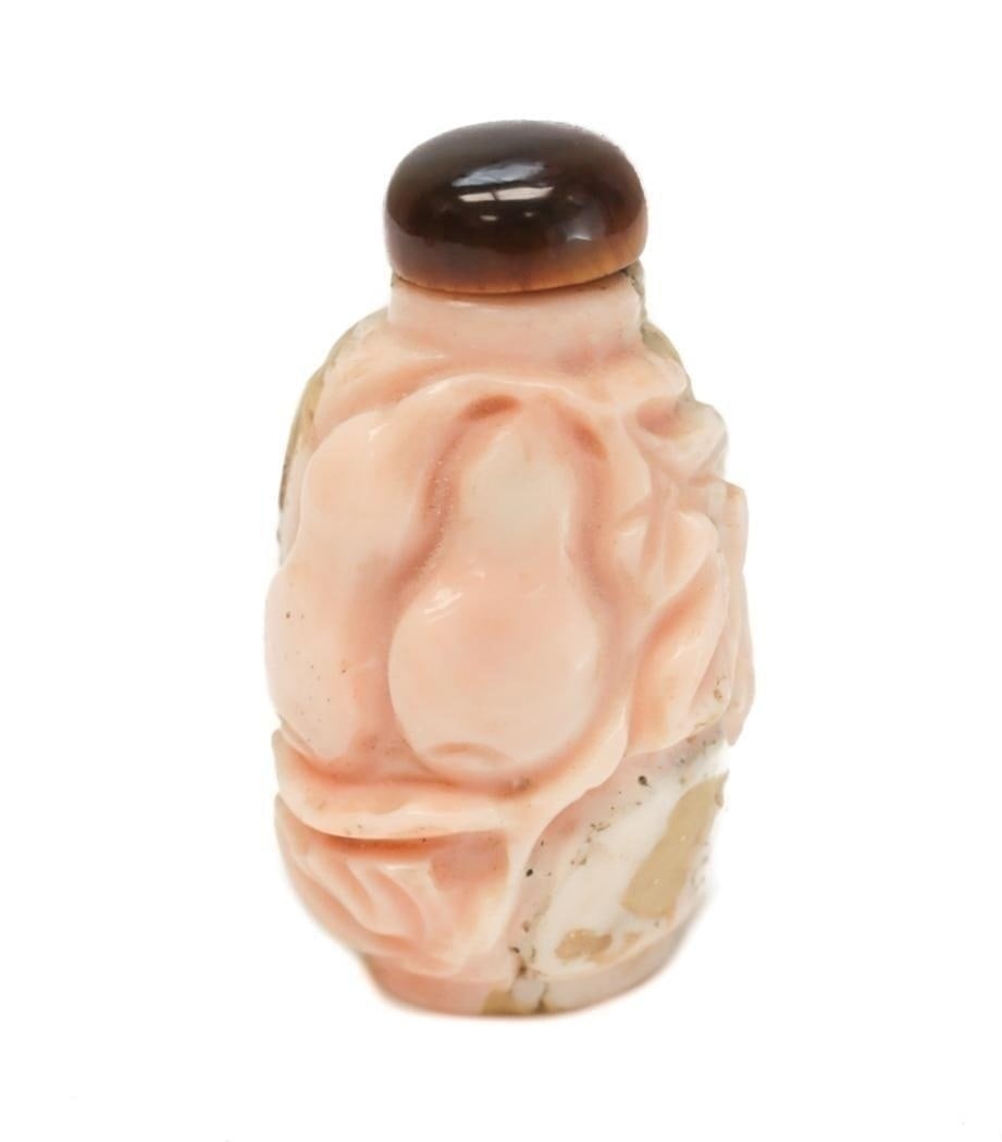 Hand Carved Coral Snuff Bottle, Animals and Fruits: Hand Carved Coral Snuff Bottle. With animals and fruits throughout. Tiger's Eye finial. 19th Century. Weight: 28 grams Measurements: Approx. 1.75 inches tall x 1 inch wide Condition: Likely areas of r