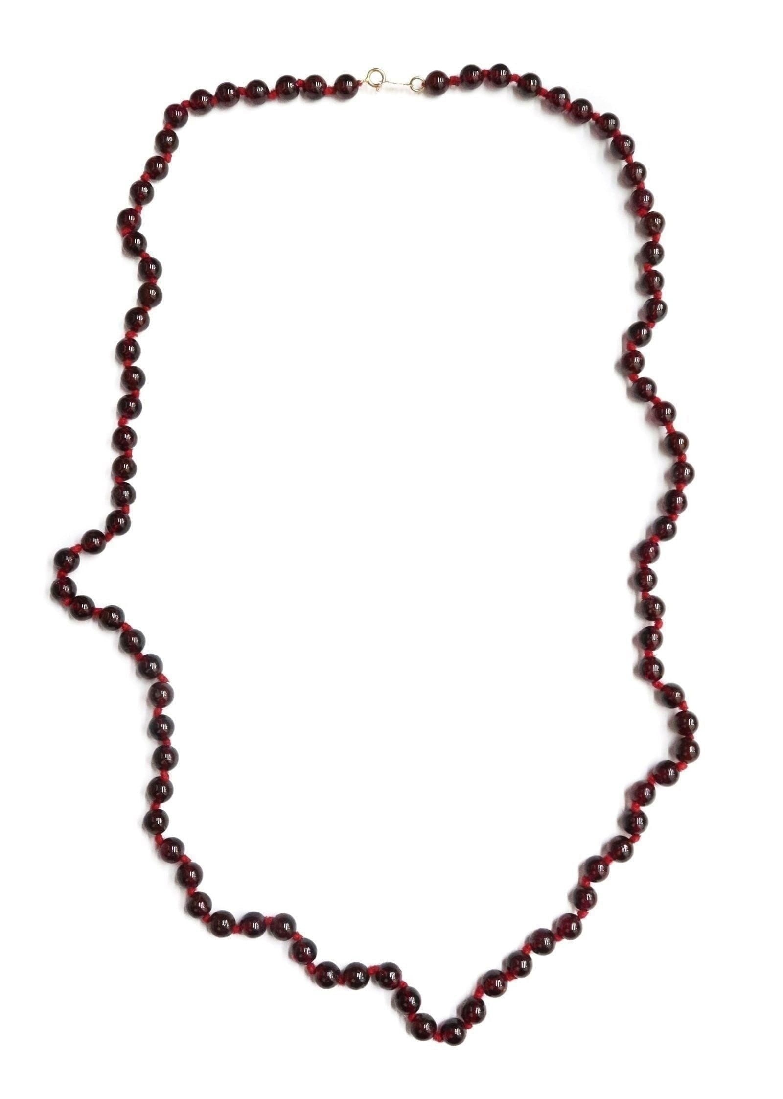 14k Yellow Gold and Garnet Single Strand Necklace: 14k Yellow Gold and Garnet Single Strand Necklace. Garnet beads measuring approximately 5.6mm. Marked "14k" and maker mark "RGE" to clasp. Weight Approx., 34.48 grams Measures Approx., 24 inches Domes