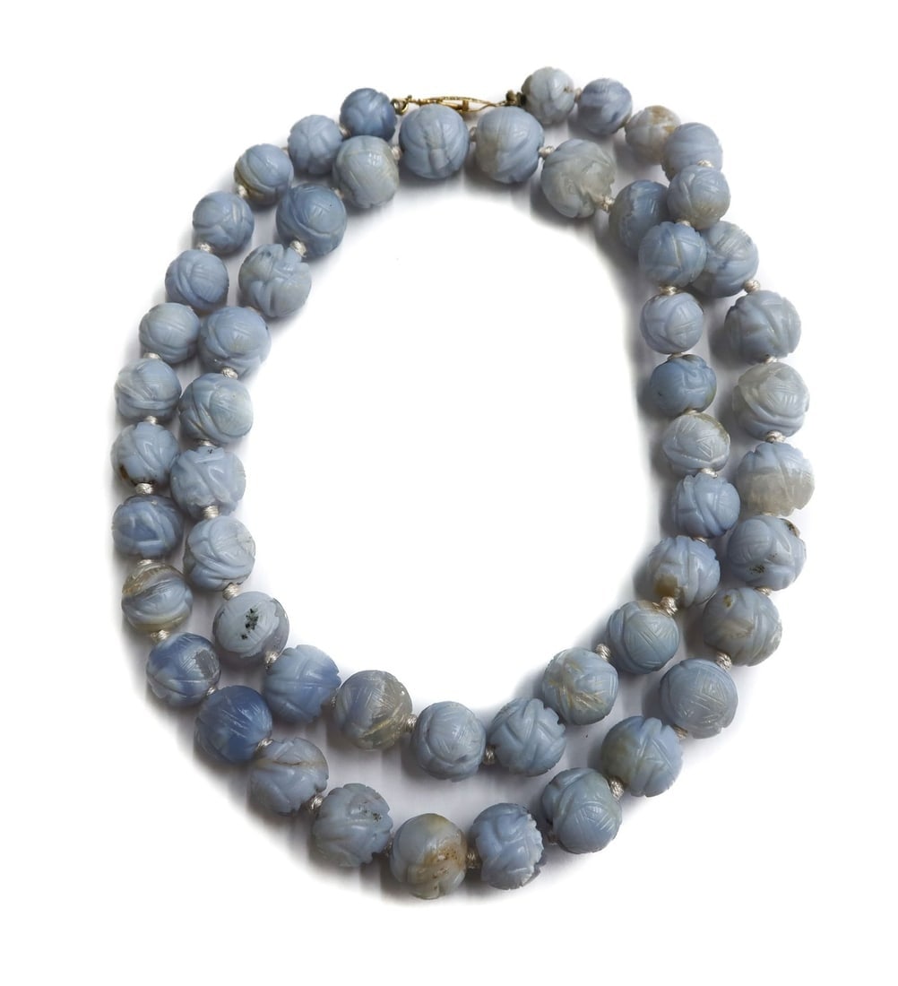14k Yellow Gold and Carved Blue Agate Knotted Graduated Single Strand Necklace: 14k Yellow Gold and Carved Blue Agate Knotted Graduated Single Strand Necklace. Carved blue agate beads in geometric shapes measuring approximately from 10.7mm to 13.9mm . Marked 14k to fisheye clasp.