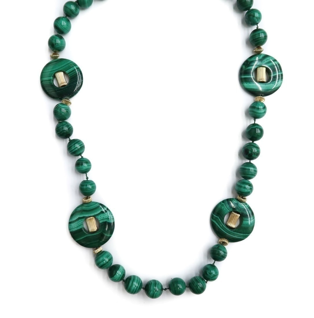 14k Yellow Gold Malachite Necklace: 14k Yellow Gold and 11.9mm Malachite Necklace. 4 carved disc accents. Clasp marked 14k. Weight Approx., 116 grams Measures Approx., 26 inches length Domestic Shipping: $25