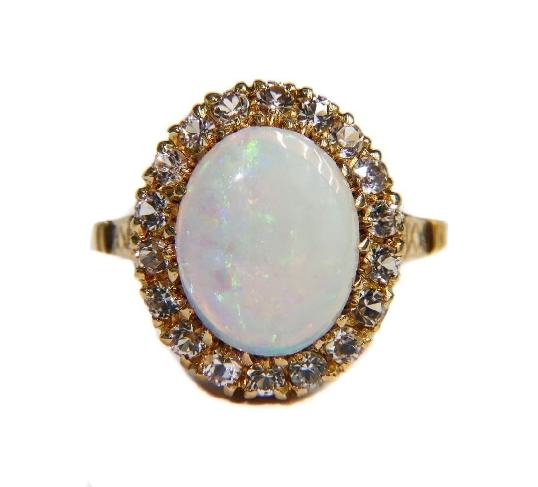 10k Yellow Gold White Opal and White Topaz Ring, Size 6: 10k Yellow Gold White Opal and White Topaz Ring, Size 6. Oval cabochon cut white opal center with round cut white topaz jewels to halo. Marked "10k" to inner band with maker mark "S" Weight Approx., 3