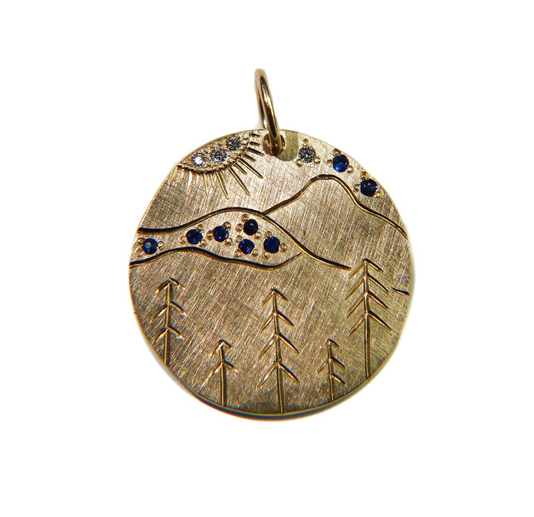 Julez Bryant 14k Yellow Gold Blue Spinel and Diamond Charm Mountain Pendant: Julez Bryant 14k yellow gold dark blue spinel and diamond charm pendant. The pendant depicts the Blue Ridge Mountains in the Appalachian Highlands. Dark blue spinels and round cut diamonds- the diamon
