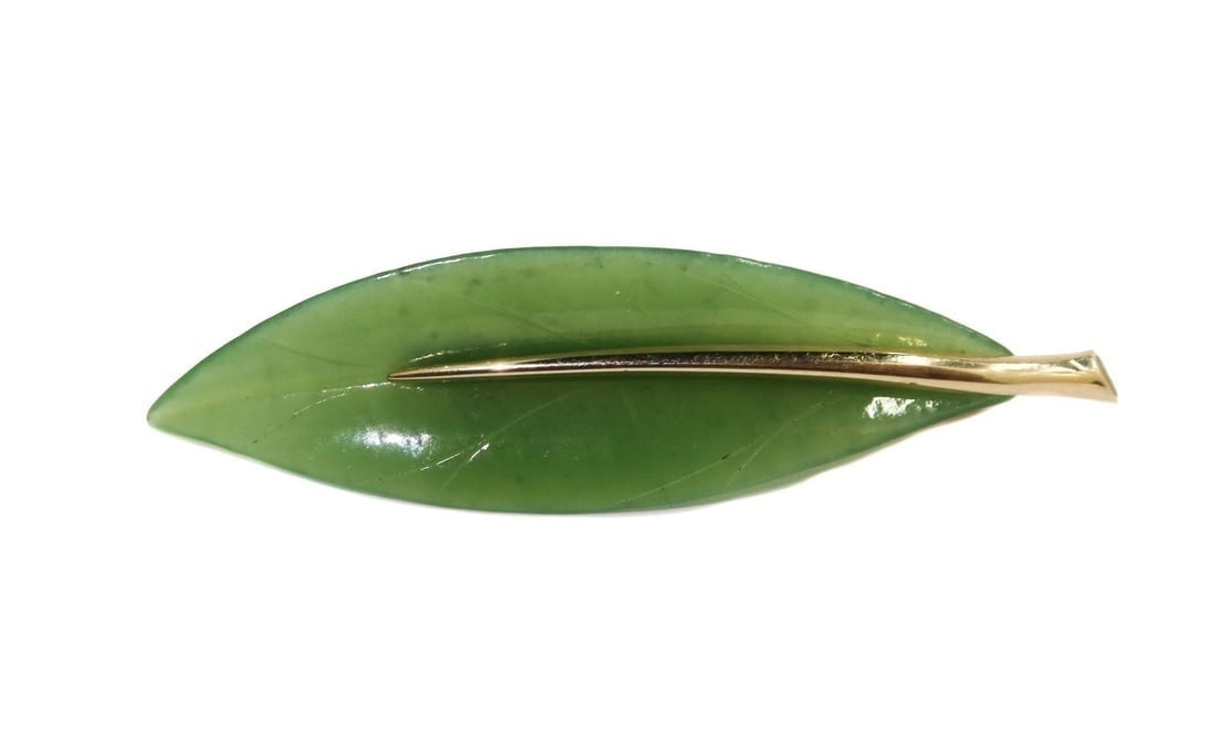 Gump's 14k Yellow Gold and Jade Leaf Brooch: Gump's 14k Yellow Gold and Jade Leaf Brooch. Marked Gump's 14k to back Weight Approx., 7.51 grams Measures Approx., 2.625 inches x 0.75 inches Domestic Shipping: $25