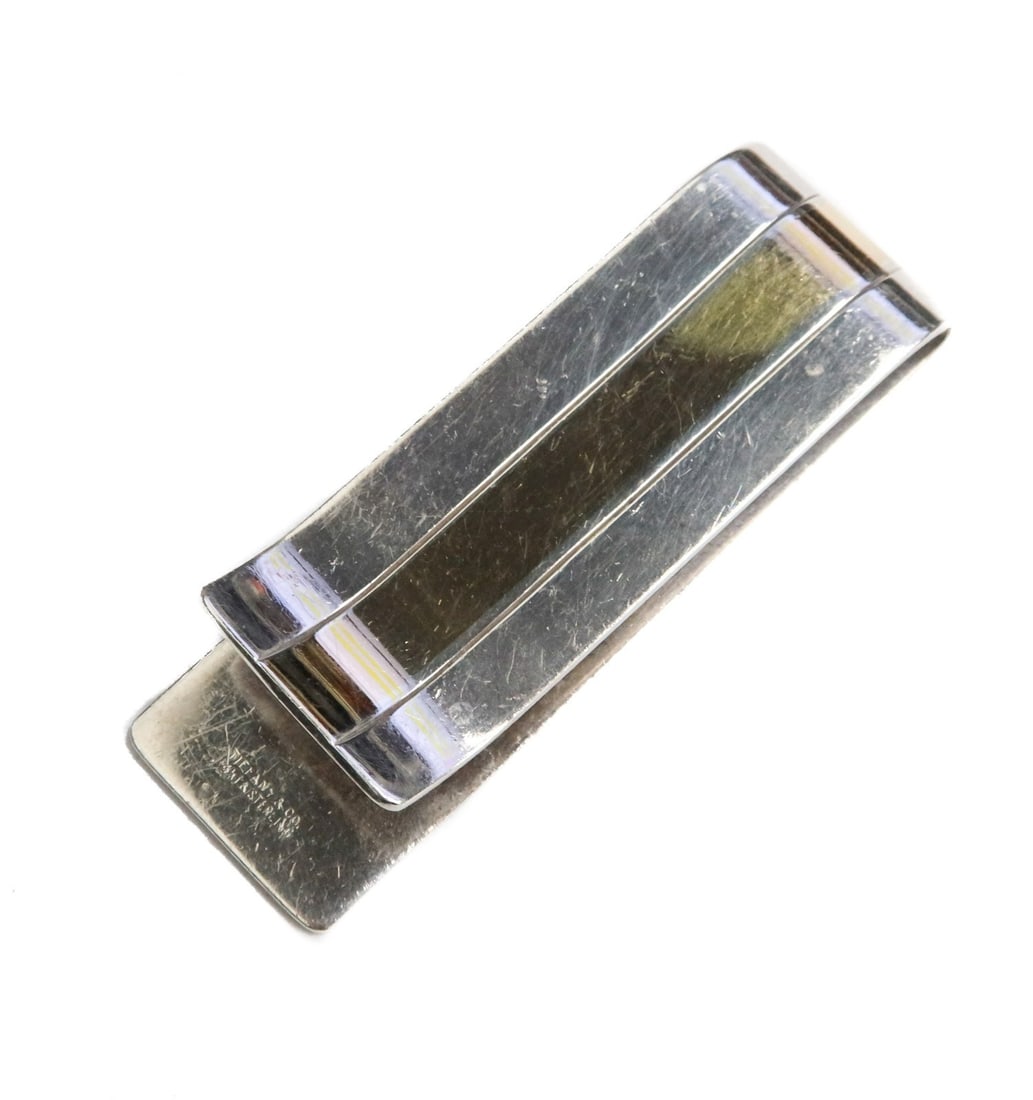 Tiffany & Co. Sterling Silver and 14k Yellow Gold Money Clip: Tiffany & Co. sterling silver and 14k yellow gold money clip. Sterling silver with a 14k gold stripe down the middle. Marked to edge. Weight:approx. 20 grams Measurements: Approx. 2.25 inches length x