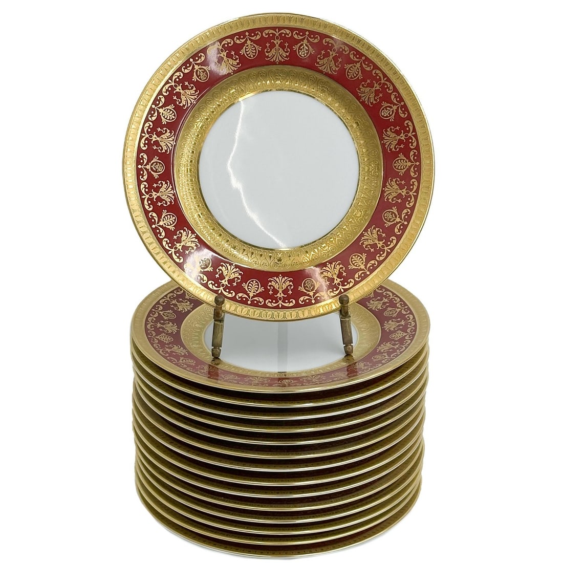 15 Raynaud Limoges France Gilt Porcelain 7.5in Dessert Plates in Eugenie Rouge: 15 Raynaud Limoges France Gilt Porcelain Dessert Plates in Eugenie Rouge. A burgundy red ground to the edge with ornate gilt decoration, raised accents. Underside marked Raynaud Limoges "Eugenie"From 