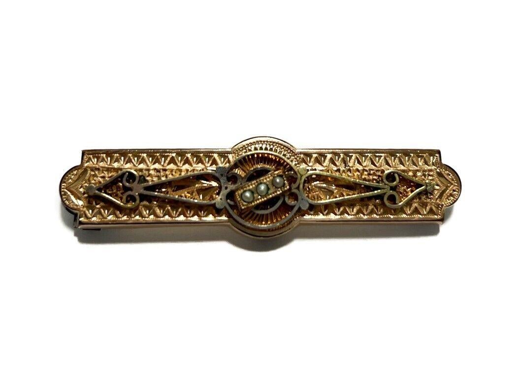 Gilt Metal Black Seed Pearl Brooch.: Gilt Metal Black Seed Pearl Brooch. Etched florals to the face with 3 applied black seed pearls to the center. Unmarked. Weight Approx., 8.3 grams Measures Approx., 2.25 inches x 0.6 inches x 0.25 inc