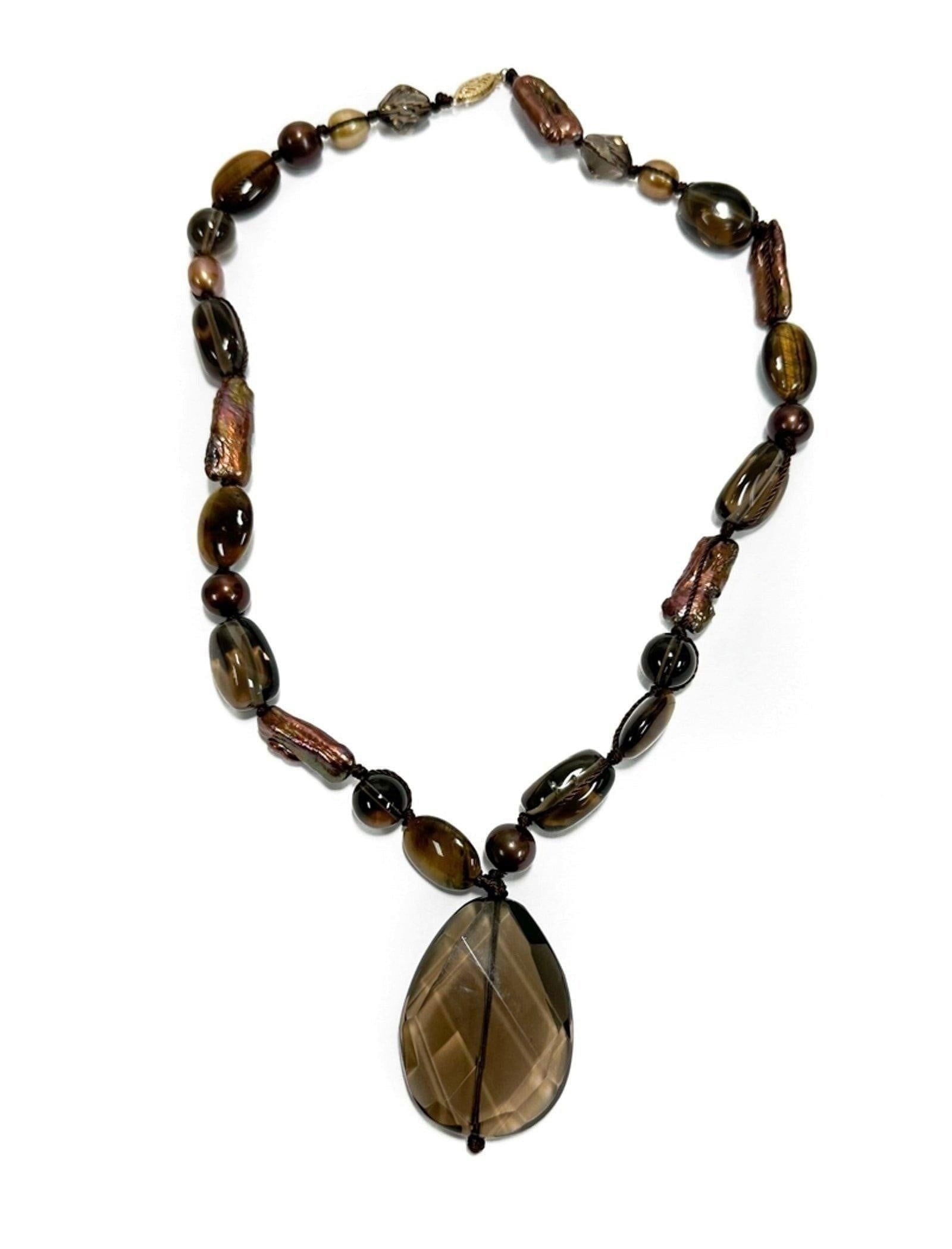 14k Yellow Gold Smokey Quartz and Natural Purple Pearl Necklace: 14k Yellow Gold Smokey Quartz and Purple Pearl Necklace. Large smoky quartz centered drop bead. The strand with tumbled and faceted smoky quartz purple pearls. Marked "585" to gold clasp. Weight Appro