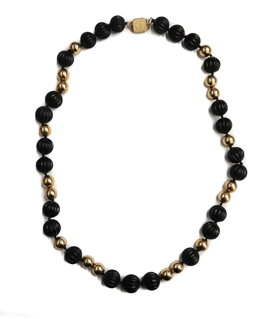 14k Yellow Gold and Black Coral Beaded Necklace: 14k yellow gold and black coral beaded necklace. 25 carved coral black beads measuring approximately 14.8mm. The gold beads measuring approximately 11.10mm. Marked 14k to clasp. Weight: Approx. 113.7 