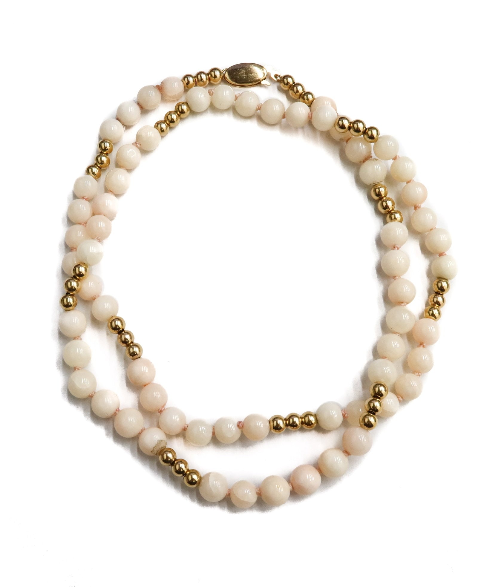 14k Yellow Gold and Pink Coral Beaded Necklace: 14k Yellow Gold and Pink Coral Beaded Necklace. Coral beads measuring approximately 6.07mm. Gold spacers measuring 3.85mm. Marked 14k to clasp. Weight Approx., 21.06 grams Measures Approx., 20.5 inche