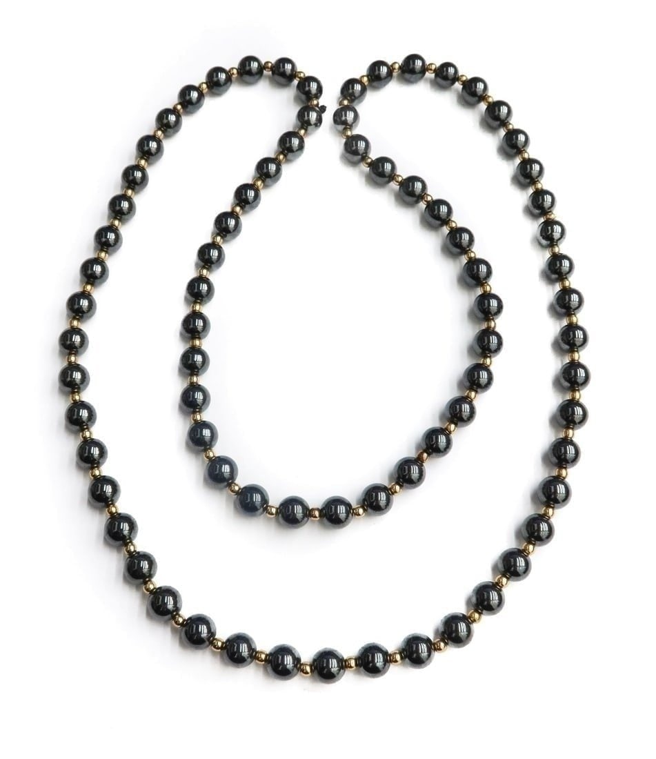10k Yellow Gold Hemitite Single Strand Necklace: 10k Yellow Gold Hemitite Single Strand Necklace. Hemitite beads measuring approximately 8mm. The gold bead spacers tests for 10k gold. Weight Approx., 45 grams Measures Approx., 31 inches length Domes