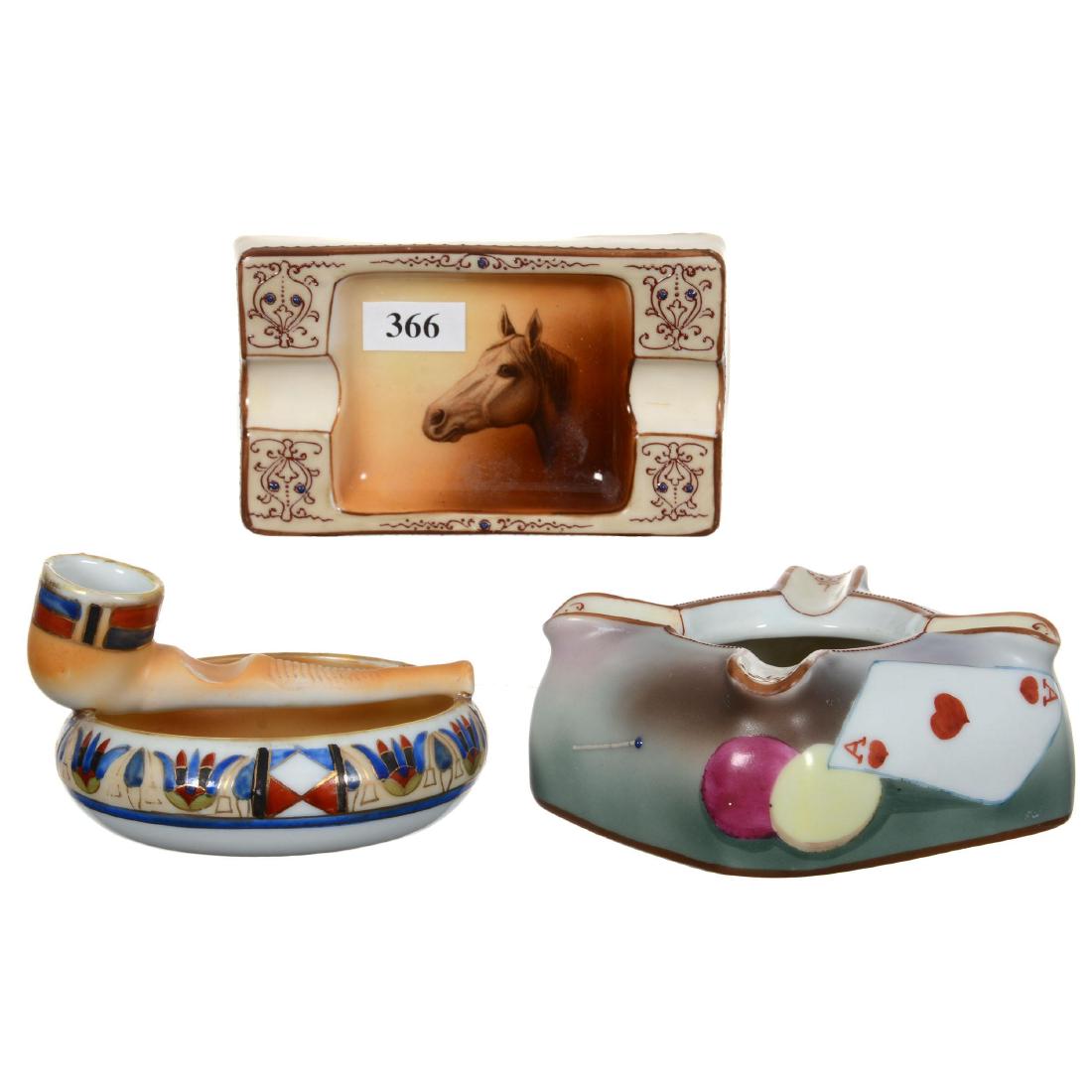 (3) Nippon (Green Wreath) Ashtrays: (3) Nippon (Green Wreath) Ashtrays (1) 4" Figural Pipe with Striker, Professional Repair - (1) 4.75" Rectangular with Horse Head Design - (1) 4" Square Featuring Playing Cards, Poker Chips and Pipe De
