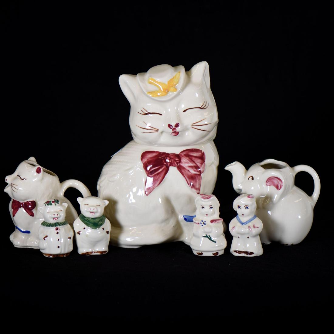 (7) Shawnee Art Pottery Figural Items: (7) Shawnee Art Pottery Figural Items Including - (1) 10" Puss 'N Boots Cookie Jar - (1) 4.5" Puss 'N Boots Creamer - (1) 4.5" Elephant Creamer - Pair 3" Pig Salt & Pepper Shakers - Pair 3.25" Man