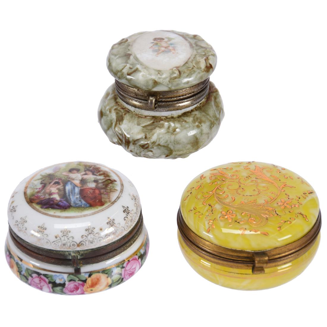 (3) Pill Boxes with Hinged Lids: (3) Pill Boxes with Hinged Lids - (1) 2.25" Yellow and White Cased Art Glass with Enamel Decor - (1) 2.5" Marked Austria with Classic Scene of Three Women in Garden - (1) 2" Green and White Mottled Po