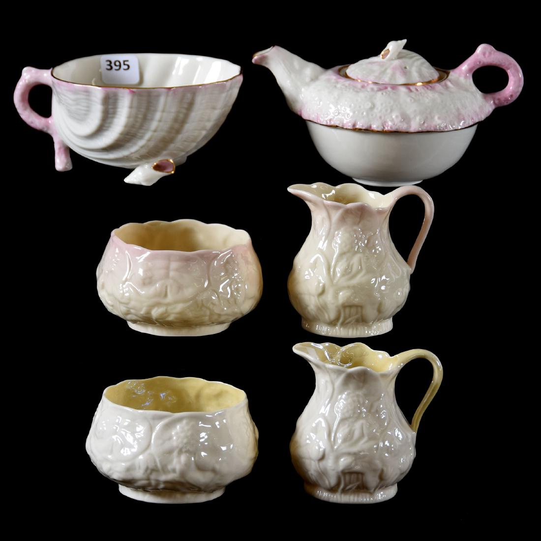 (6) Irish Belleek Items: (6) Irish Belleek Items Including - (1) 3" Pink & White Tea Pot, Unmarked - (2) Sets of Creamers & Sugars, Green Mark - (1) 2.25" Shell Mold Footed Cup