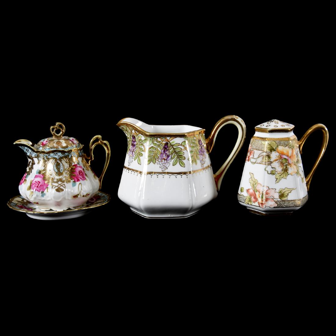 (3) Marked Nippon Items, Floral Decor: (3) Marked Nippon Items with Floral Decor; (1) 5", Six-Sided Pitcher, White with Wisteria Decor; (1) 5", Six-Sided Handled Muffineer, White with Poppy Decor; (1) 4.75" Syrup Pitcher with Matching Unde