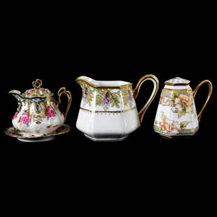 (3) Marked Nippon Items, Floral Decor: (3) Marked Nippon Items with Floral Decor; (1) 5", Six-Sided Pitcher, White with Wisteria Decor; (1) 5", Six-Sided Handled Muffineer, White with Poppy Decor; (1) 4.75" Syrup Pitcher with Matching