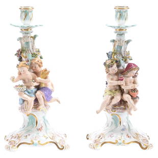 Pair Marked Meissen Figural Candlesticks: Pair Marked Meissen Figural Candlesticks, 13.5", Blue Crossed Swords Mark with Inscribed "128" and "129" Model Numbers, Each Features Two Cherubs with Applied Floral Design, Tip of One Toe Missing,