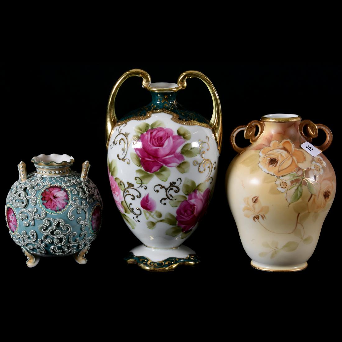 (3) Nippon Handled Vases: (3) Nippon Handled Vases; (1) 7.75", White and Dark Green with Pink Rose Decor, Unmarked; (1) 6", Brown with Rose Decor, Marked; (1) 4.5", Footed, Green with Moriaga Decor and Pink Rose Highlights, Un