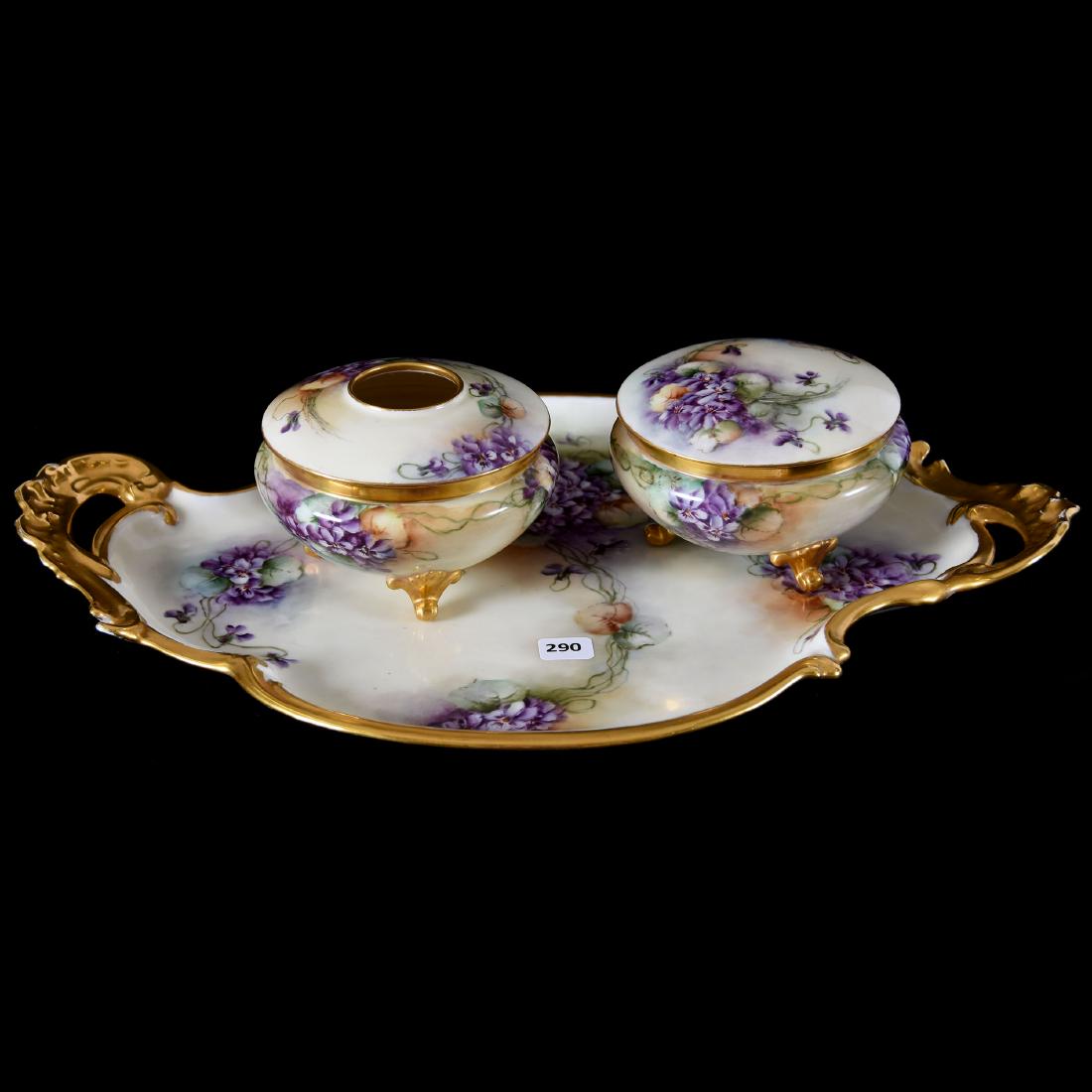 Three Piece Hand-Painted Limoges Dresser Set: Three Piece Hand-Painted Limoges Dresser Set, Decor of Violets on Cream Background, Heavy Gold Trim, Artist Signed "Dear Baugh"; (1) 18" X 12" Tray with Matching Footed Hair Receiver and Powder Box