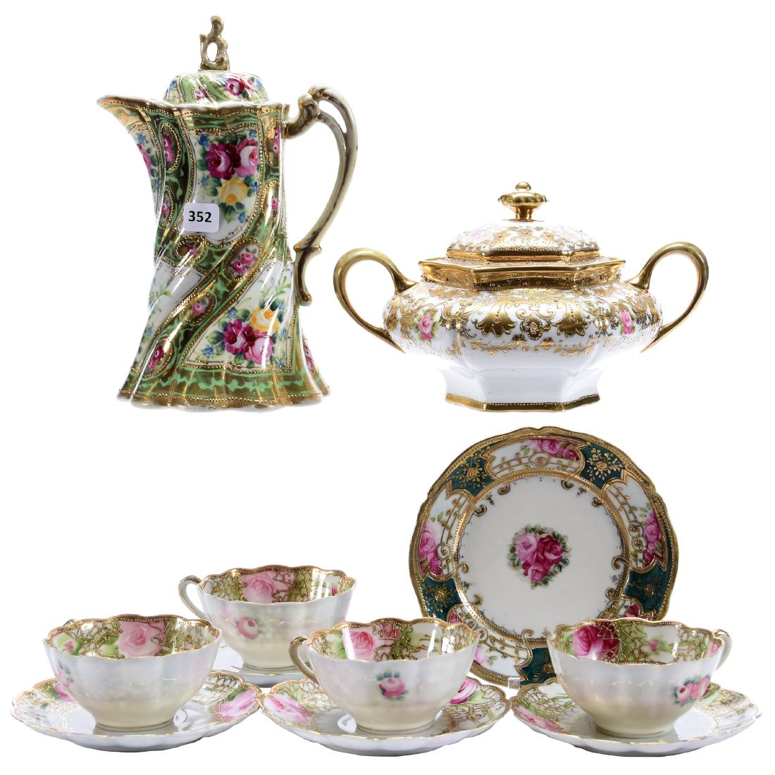 (7) Nippon Items: (7) Nippon Items; (1) 9.5" Chocolate Pot Marked Nippon; (1) 5.5" Six-Sided Cracker Jar, Heavy Gold; (1) 6.5" Plate, Marked; (4) Marked Nippon Cups and Saucers, All with Nice Gold