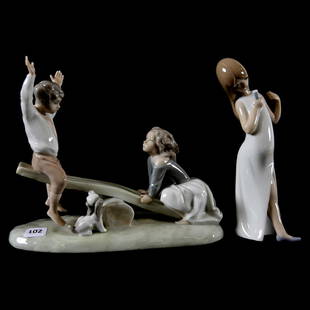 (2) Porcelain Figurines: (2) Porcelain Figurines; (1) 7.75" X 9.5" Boy and Girl on Seesaw with Puppy Watching, marked "Nao" by Lladro; (1) 7.5" Marked Lladro, Young Girl Singing in Nightgown