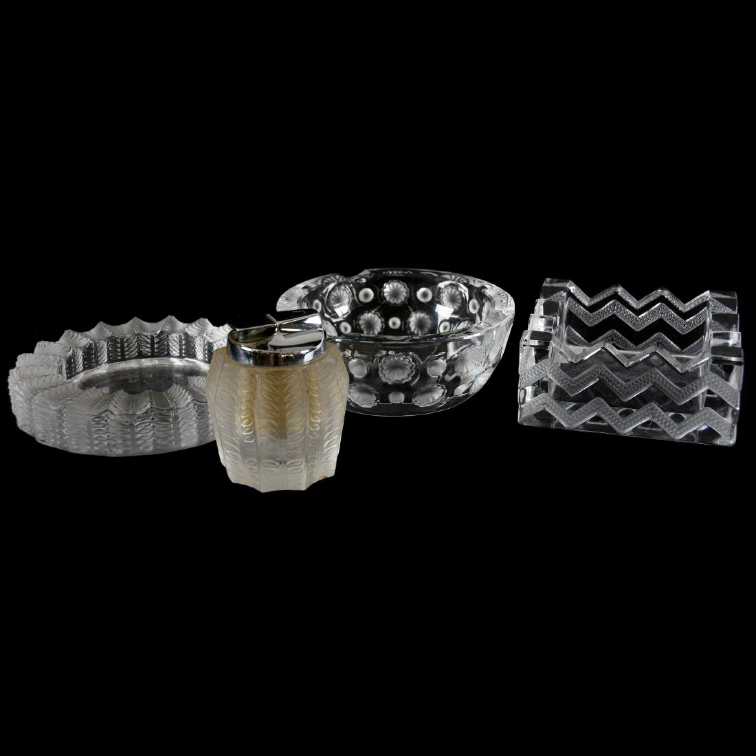 (4) Smoking Accessories, Signed Lalique France: (4) Signed Lalique France Smoking Accessories; (1) 4.5" Square Ashtray, Soudan Design, Small Rim Chip; (1) 5.25" Round Ash Tray, Tokyo Design; (1) 5.5" Round Ash Tray, Jamaique Design; (1) 3.25" Cigar
