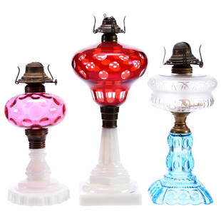 (3) Kerosene Lamps: (3) Art Glass Kerosene Lamps; (1) 15.5" Ruby to Clear with Bullseye Motif, Milk Glass Base; (1) 13" Frosted Font with Blue Art Glass Base; (1) 11.5" Cranberry Coinspot with Milk Glass Base