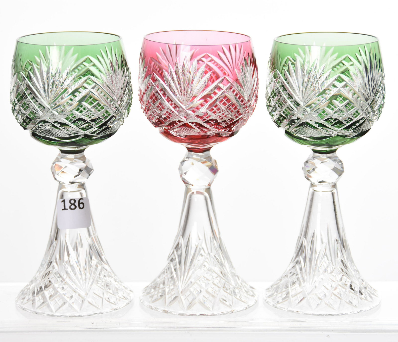 (3) Wine Stems, Val St. Lambert: (3) Wine Stems by Val St. Lambert, BPCG, 6" Design 3344/17, Circa 1905, Petticoat Clear Base, Lapidary Cut Knob Stem; (1) Cranberry; (2) Green