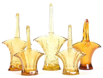 (5) Solid Amber Glass Baskets by Duncan Miller: (5) Solid Amber Glass Baskets by Duncan Miller 14", 12", 10.75", 9.5" (1) 14" Floral design; (1) 12" Floral design; (1) 10.75" Swirl design; (1) 9.5" Panel design; (1) 9.5" Panel & engraved floral