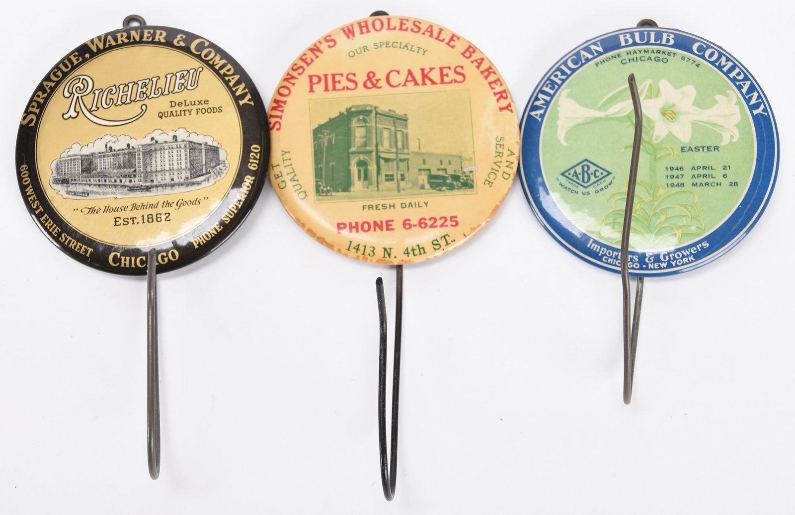 (3) Celluloid Advertising Bill File / Receipt Hooks: (3) Celluloid Advertising Bill File / Receipt Hooks 3.25" diameter Includes: American Bulb Company, Chicago; Simonsen's Wholesale Bakery, St. Joseph Missouri; Sprague, Warner & Co., Chicago; Nancy Rub