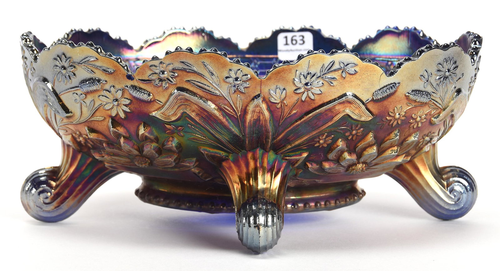 Carnival Glass Footed Banana Bowl, Thistle Pattern: Carnival glass footed banana bowl, Thistle pattern; 4" x 10.5" Blue by Fenton, water lily and cattail exterior - nice color; Don Anderson Collection, Kansas
