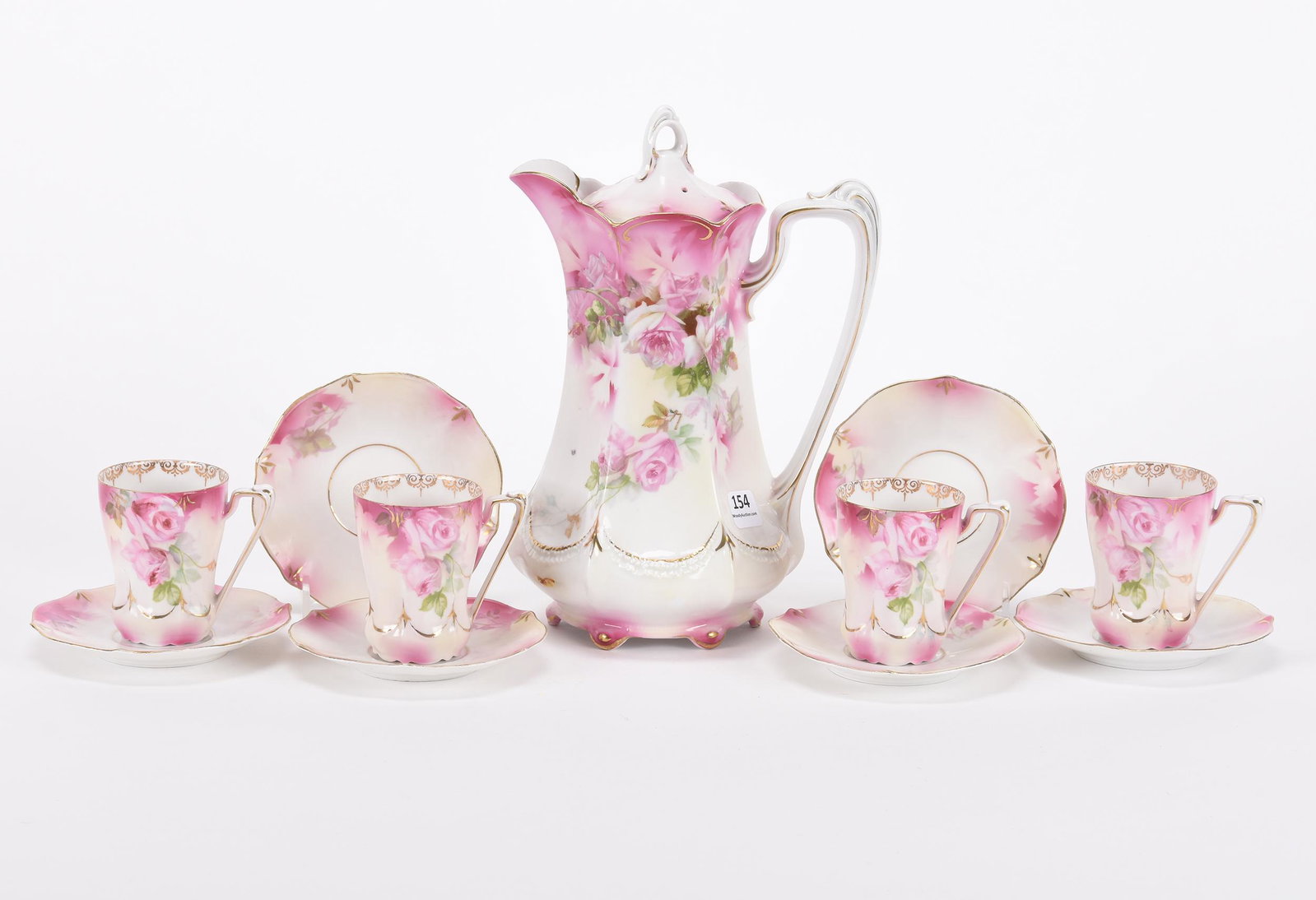 Chocolate set marked R.S. Prussia: Chocolate set marked R.S. Prussia; 9.5" Pink and white tones with rose decor, chocolate pot and (4) matching cups and saucers, two extra saucers included ; Hopper Collection, Kansas
